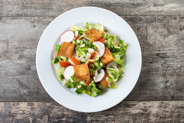 Fattoush salad, Traditional Lebanese Salad on wooden table. Top view