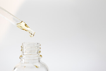 Vitamin C serum in pipette, close-up. Body skin care cosmetic product minimal