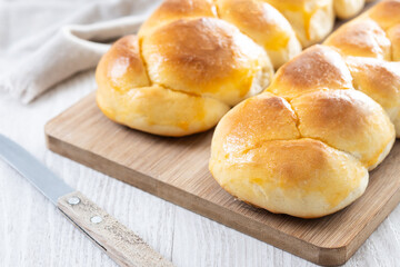 Traditional Easter braided bread. Tsoureki braid on white wooden table
