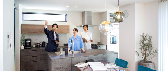 Housing sales: Japanese person explaining kitchen in model house