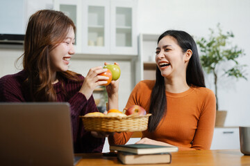 Lifestyle people,  Happy two woman enjoys breakfast sitting in the kitchen.