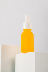 Plastic white tube for cream or lotion. Skin care or sunscreen cosmetic with stylish props on white background.