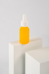 Plastic white tube for cream or lotion. Skin care or sunscreen cosmetic with stylish props on white...