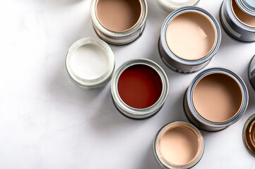 Tiny sample paint cans during house renovation, process of choosing paint for the walls, Mocha...