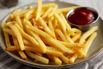 Homemade French Fries and Ketchup on a Plate, low angle view. Close-up.