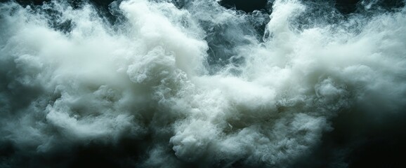 Obraz premium Dense, swirling white smoke billows against a dark backdrop, creating a dramatic, ethereal effect