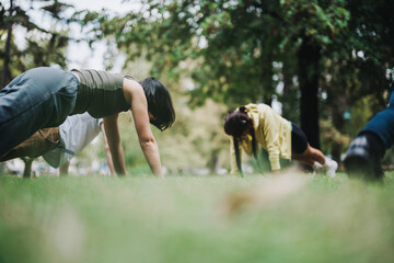 Students engage in a refreshing outdoor fitness class in a natural setting, guided by their instructor. The lush environment enhances the activity's energy and enjoyment.