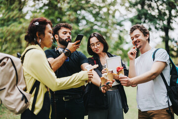 A group of diverse students relax and enjoy ice cream together in a park setting during a class break, showcasing friendship and leisure outdoors.