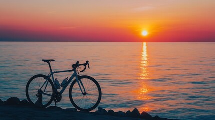Fototapeta premium Sunset coastal road bike silhouette.