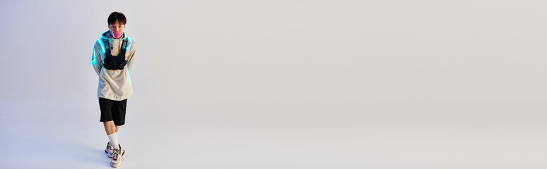 Stylish young Asian man in a trendy outfit exudes confidence in a minimalist setting