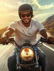 A happy man riding a motorcycle on an open highway wearing a white t-shirt, sunglasses, and a helmet