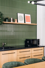 Modern kitchen design featuring green accents and wooden cabinetry