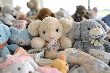 Tea party featuring adorable stuffed animals with tiny teacups in a bright and cheerful setting