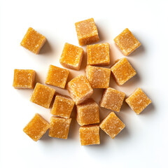 A top down view of a scattered pile of small orange sugar cube candies