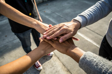 Hands Stacked Together Representing Unity and Teamwork