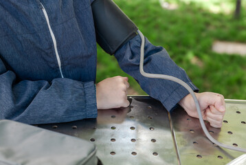 
Young boy measuring blood pressure in a park. Concept of children’s health, early diagnosis, and...