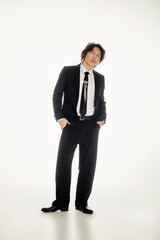 Stylish young asian man posing confidently in a chic urban setting with modern flair
