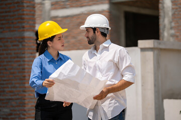 Construction engineers supervising progress of construction project. engineering or worker in safety vest observing a building. worker, Architecture, engineer, architect wearing safety helmet meeting.