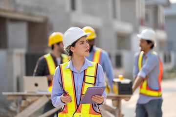 construction, workers. A team of construction engineers talks to managers and construction workers at the construction site. Quality inspection, work plan, home and industrial building design project