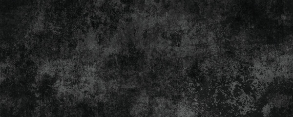 A Monochrome and Abstract Darkened Cement Surface with Cracks and Scratches

