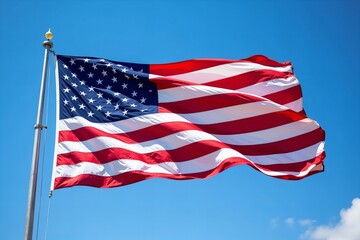 American Flag Fluttering in the Wind, Vibrant Red and Blue Colors Against Clear Blue Sky