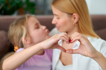 Mother and daughter sharing a loving moment in a cozy home setting  