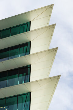 Pointed cement protrusions between glass windows of a modern high rise building