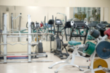 Obraz premium Interior Of The Modern Gym, With Machines And Weights, Blurred And Out Of Focus