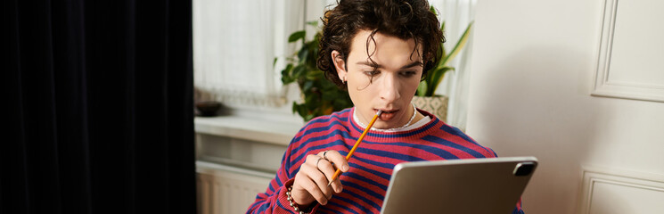 Curly-haired non binary student engaging with a tablet in a stylish apartment