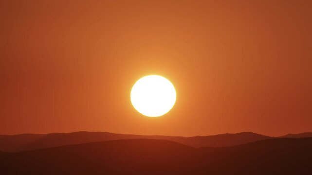 Sun close-up rising over mountain horizon. Beautiful nature video time lapse landscape.