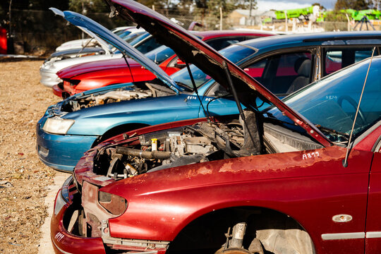Wrecked and smashed cars parked in car wreckers junkyard