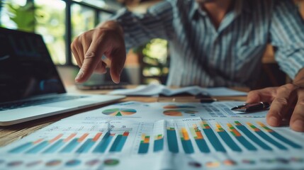 Fototapeta premium Collaborative financial strategy session with an expert pointing at growth charts discussing wealth management and future financial goals