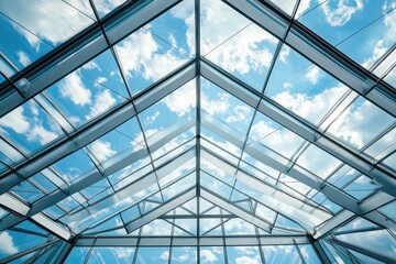 Modern glass roof structure with sky view