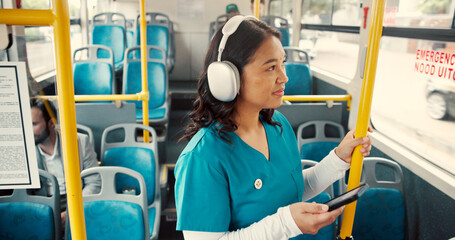Bus, travel and woman by rail with headphones for journey, morning commute and trip in city. Public transport, passenger and nurse with phone listen to music on vehicle to work, job or career in town © DavidL25/peopleimages.com