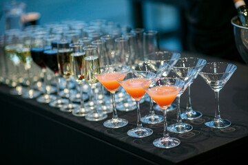 A row of martini and champagne glasses is elegantly arranged