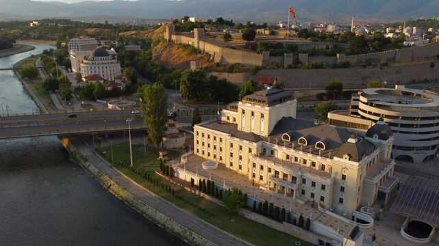 Skopje drone video over Vardar river with National Theatre and Kale Fortress with Macedonian Flag - Skopje, Macedonia