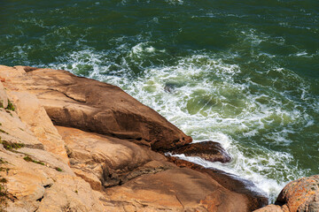 Serene Coastal View with Rocky Shoreline and Turquoise Waves