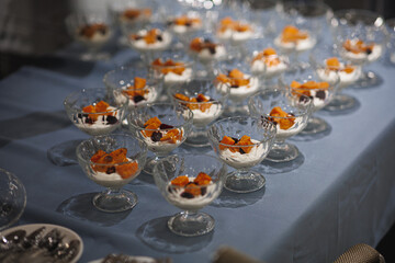 There is a table containing a wide variety of delicious desserts on it