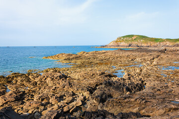 Emerald coast at sunset. Rocky coastline near Cancale in Brittany, France 