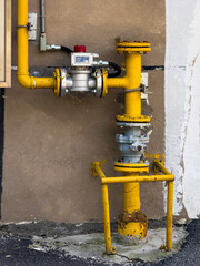 Industrial Yellow Pipeline System Against a Wall Background