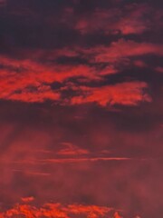 A dramatic sunset filled with deep red and pink hues.