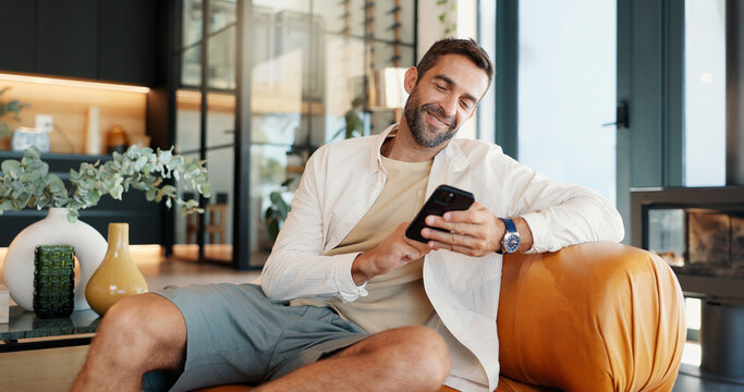 Home, relax and man on sofa, smartphone and smile with message to contact, social media and connection. Person, apartment or guy on couch, cellphone and internet with funny meme or email notification