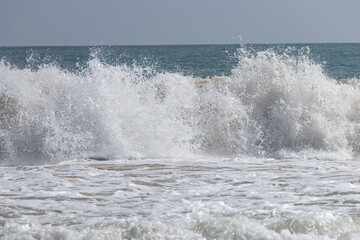 The ocean is rough and the waves are high