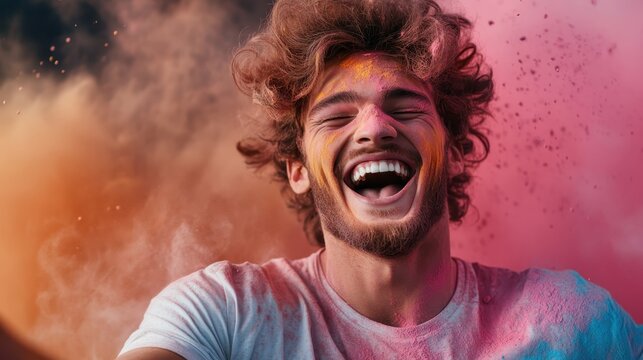 A young man laughing as vibrant colors of powder surround him, evoking a sense of joy, freedom, and the beauty of self-expression in a festive atmosphere.