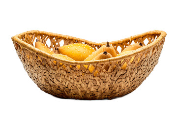 Fototapeta premium A woven basket filled with several ripe yellow mangoes against a plain black background studio shot