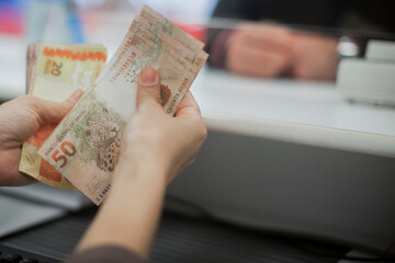 Businessman counting and exchanging money - Brazilian Real - Reais.