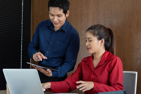 Collaborative Financial Strategy. A professional duo consults on financial reports and strategies.