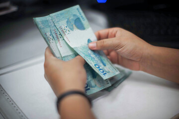 Businessman counting and exchanging money - Brazilian Real - Reais.