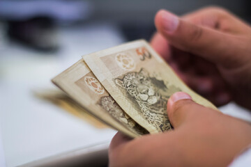 Businessman counting and exchanging money - Brazilian Real - Reais.