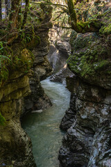 Martvili Canyon where pristine turquoise waters carve a path through ancient, moss-covered rock formations, Martvili Taleri Chkhorotsku, Georgia